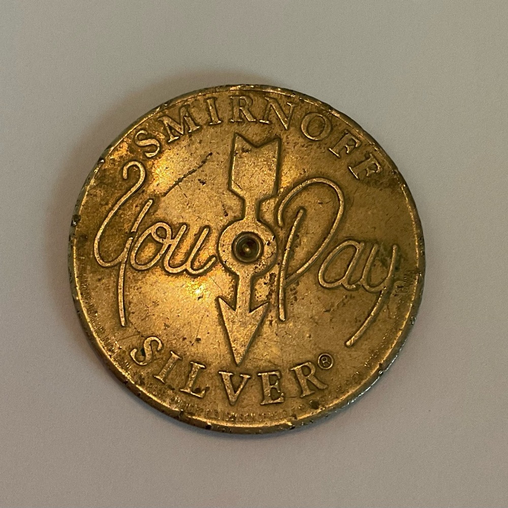 Vintage Smirnoff metal advertising spinner pay token coin leaves you breathless